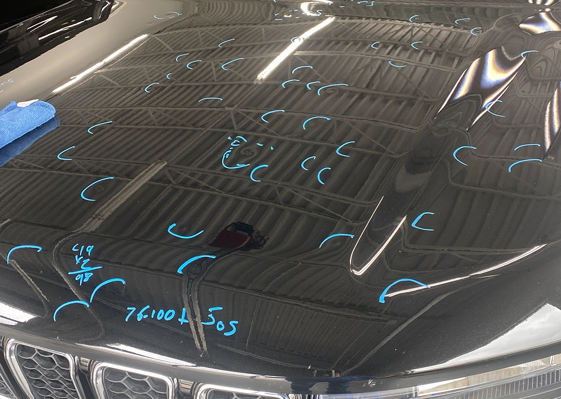 Professional paintless dent repair service for vehicle damage at Precision PDR
