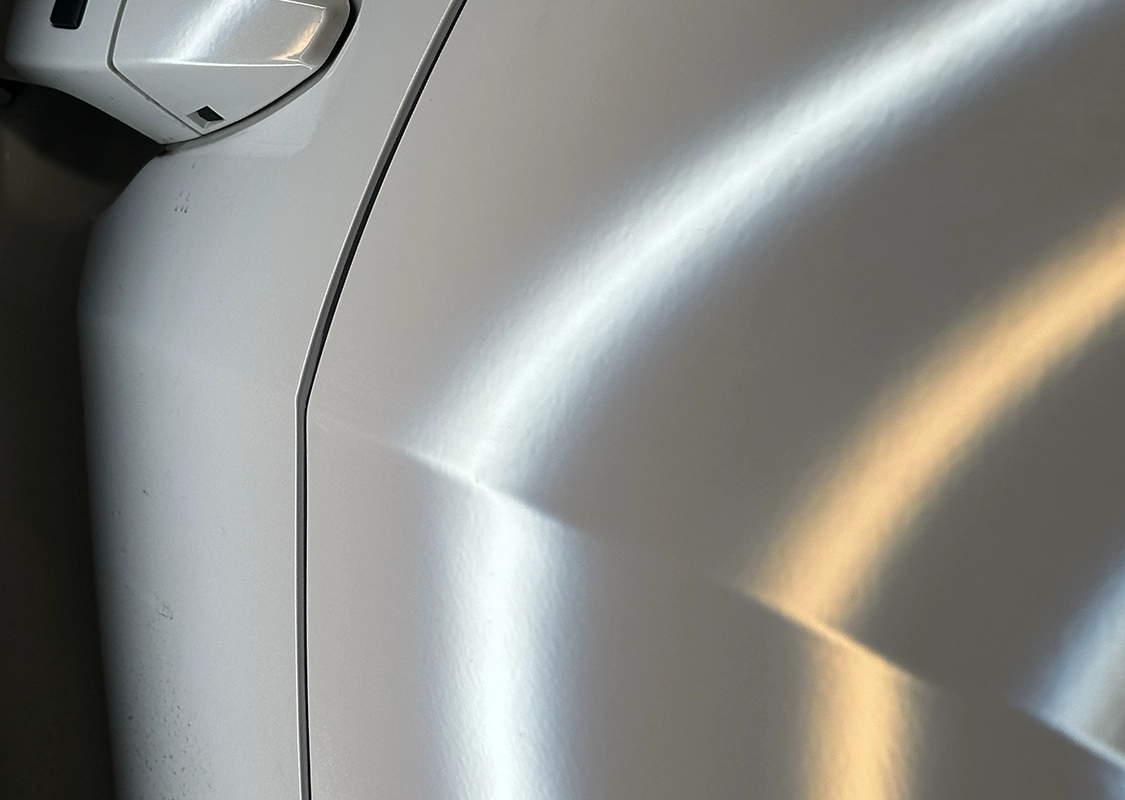 Vehicle undergoing professional paintless dent repair at Precision PDR in Denver