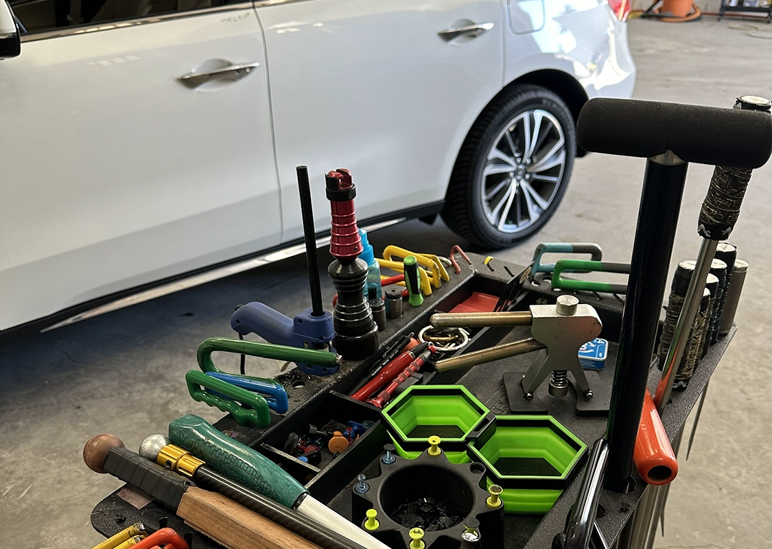 Vehicle undergoing professional paintless dent repair at Precision PDR