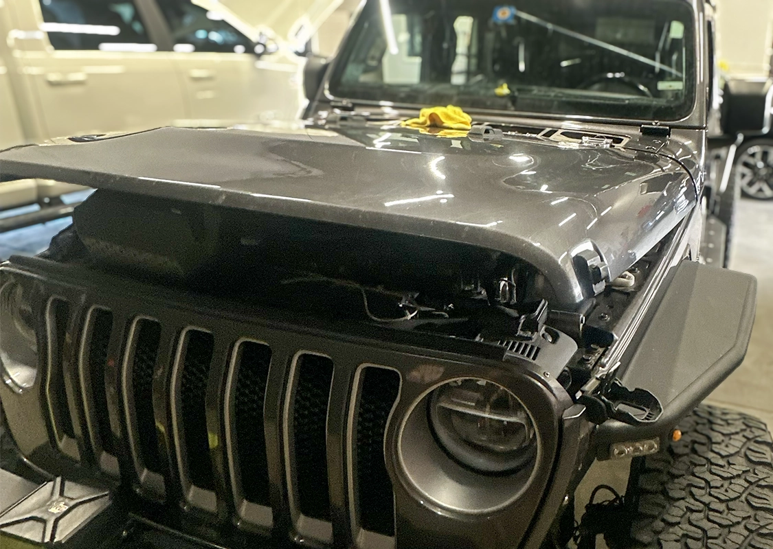 Vehicle undergoing professional paintless dent repair at Precision PDR in Denver