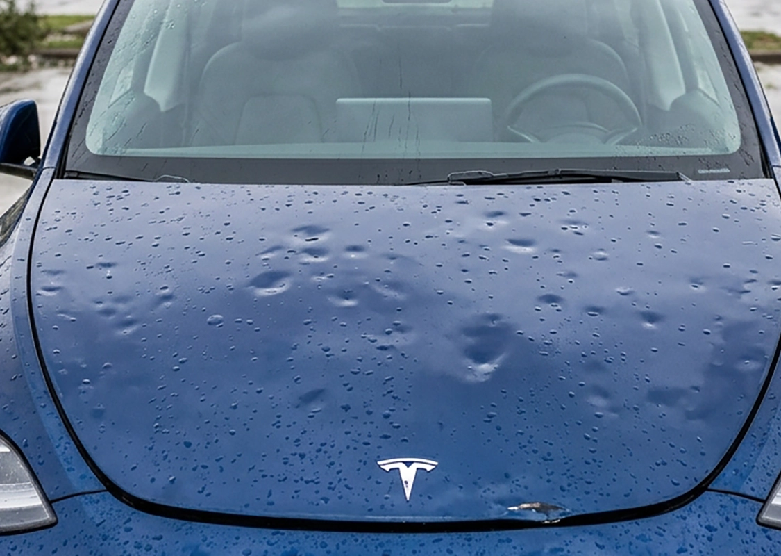 tesla_hail_damage Tesla with hail damage dents undergoing professional paintless dent repair at Precision PDR
