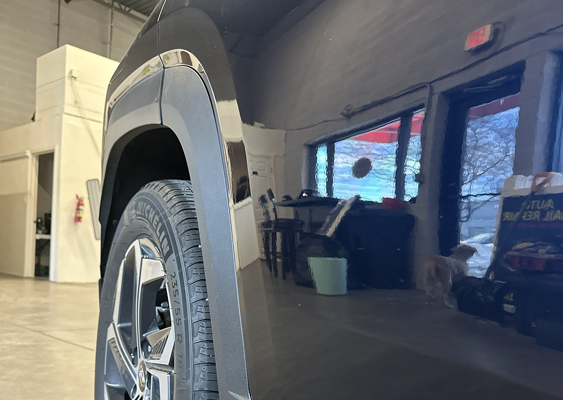 Vehicle undergoing professional paintless dent repair at Precision PDR